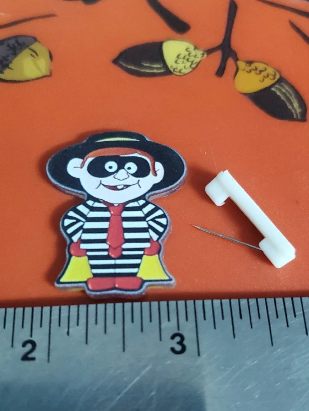 Striped Hamburger Burglar Cartoon Pin - Black, White & Red with Yellow Accent